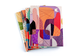 Quaderno notebooks stack by Jomike Tejido with Evening Skyline notebook on top